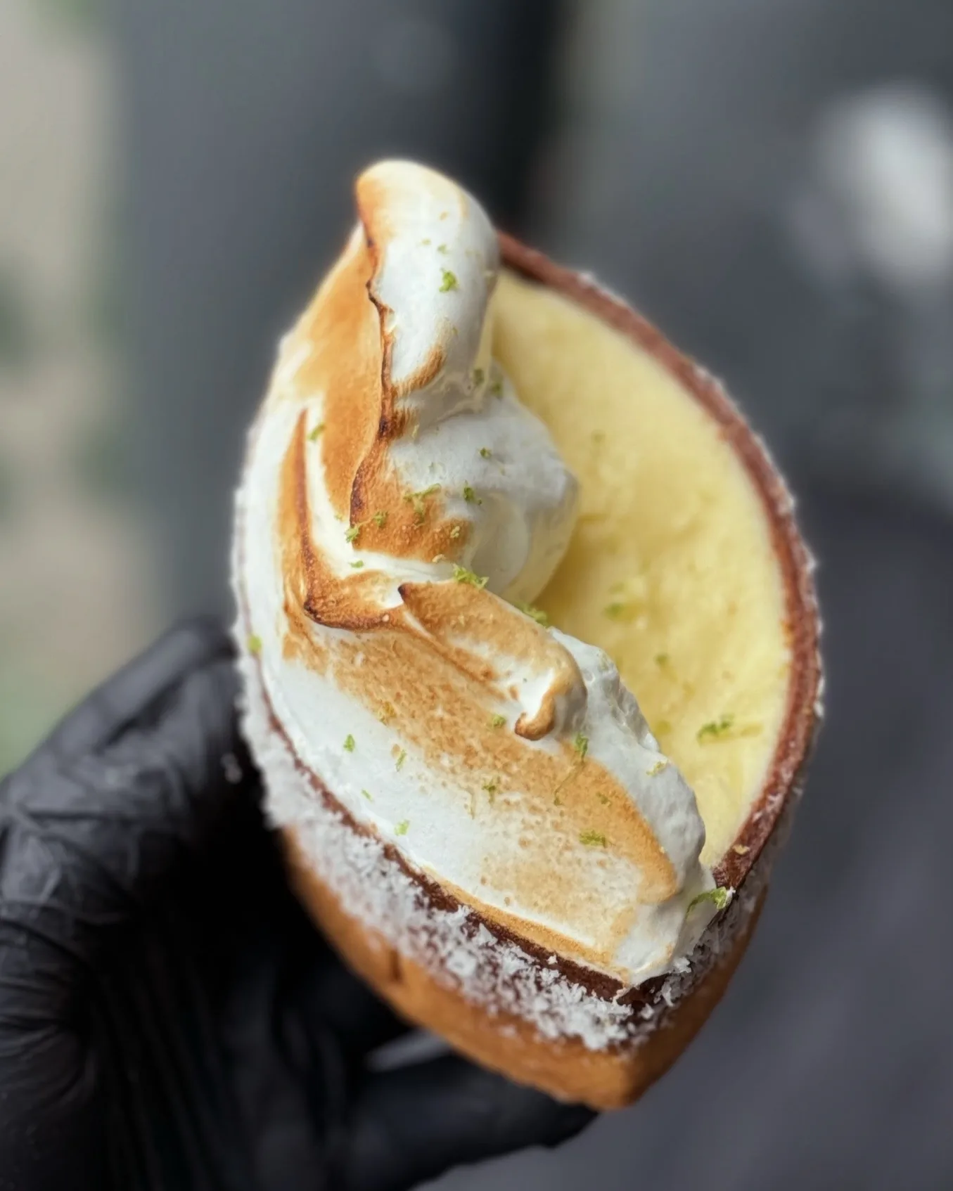 Lime Meringue Tart — torched meringue over lime curd in a coconut-rimmed sablé boat